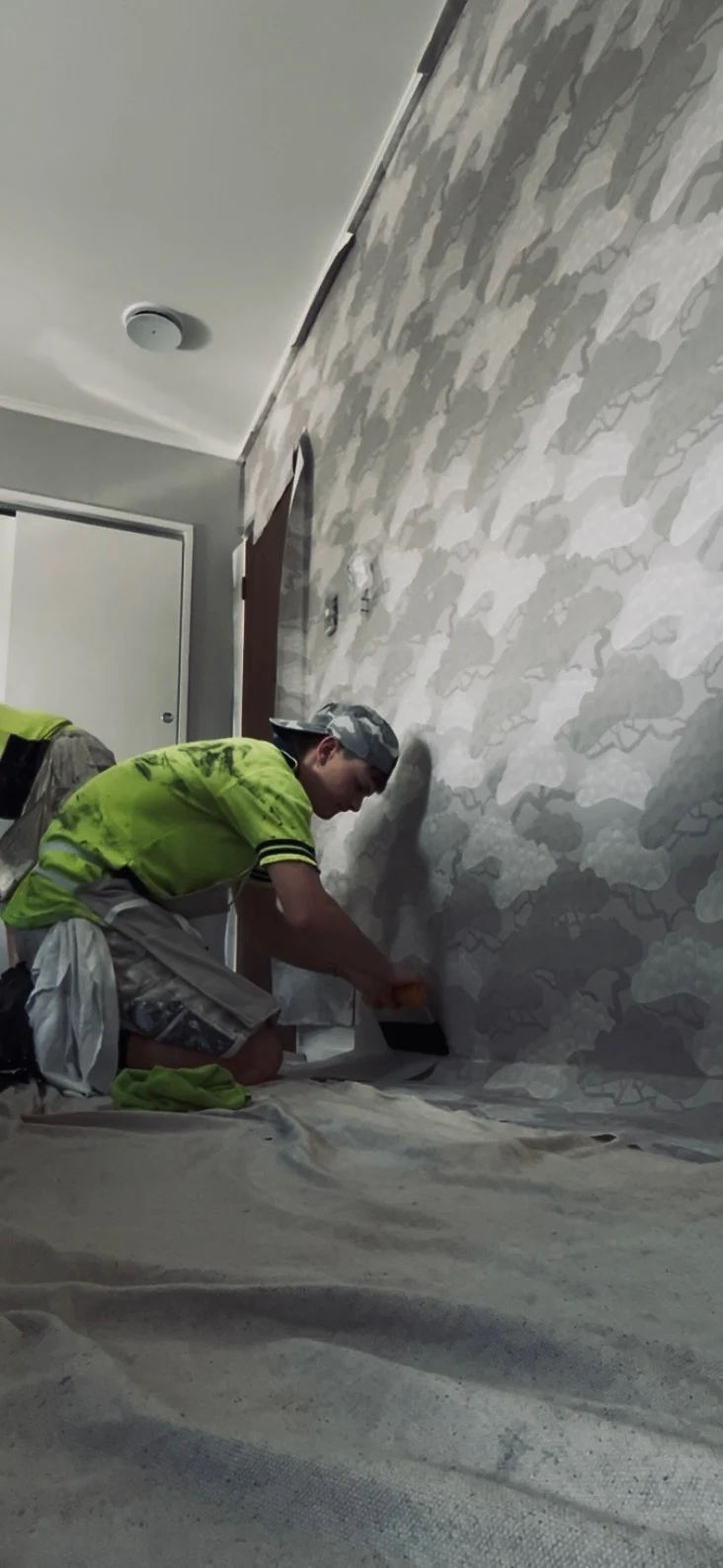 Worker coating an interior wall