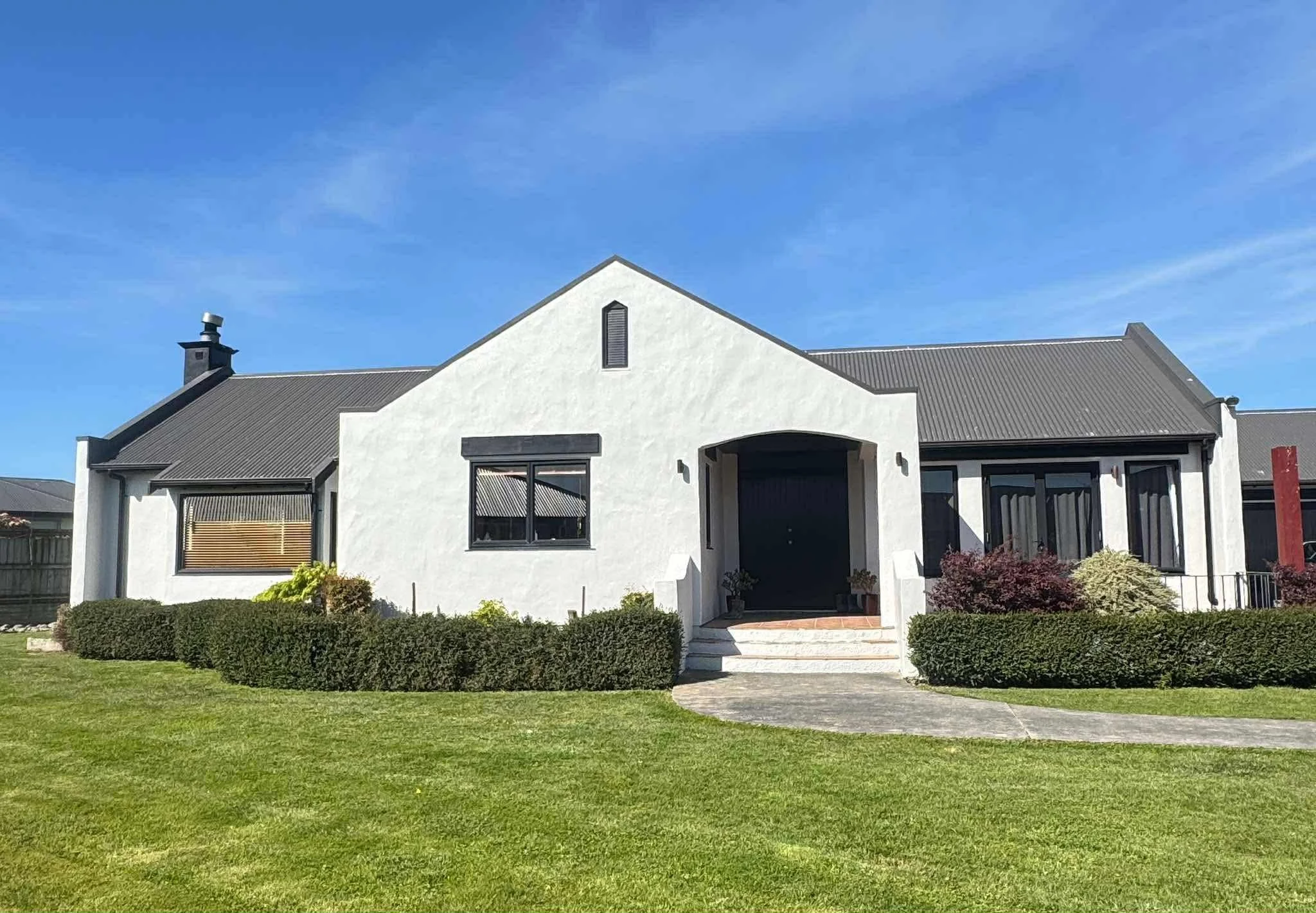 Front view of the home after repainting in white